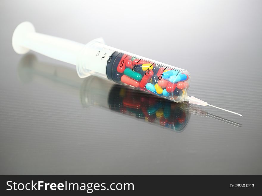 Drugs pack in syringe on gray background. Drugs pack in syringe on gray background