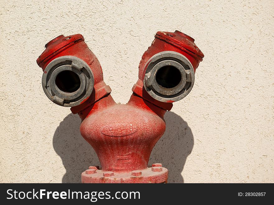 Red fire hydrant by a wall