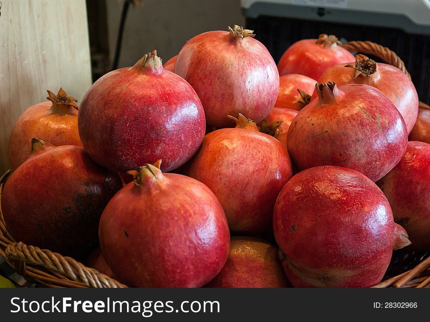 Ripe juicy pomegranates in a basket