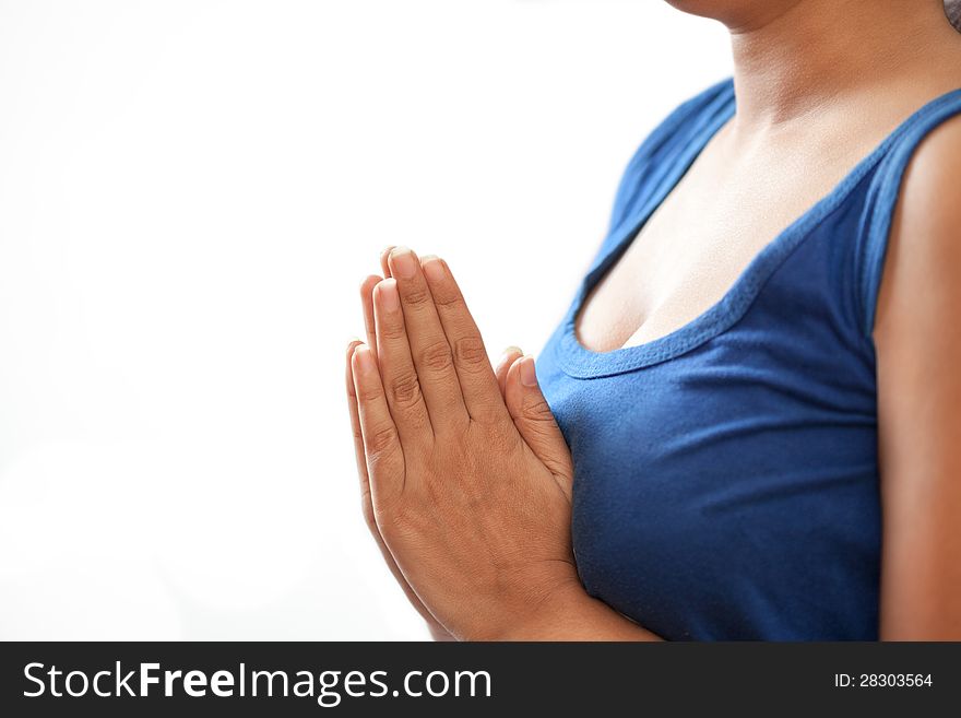 A beautiful Young Indian girl in white top doing meditation by joining hands. A beautiful Young Indian girl in white top doing meditation by joining hands