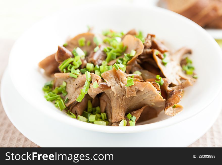 Fried mushrooms in a white bowl