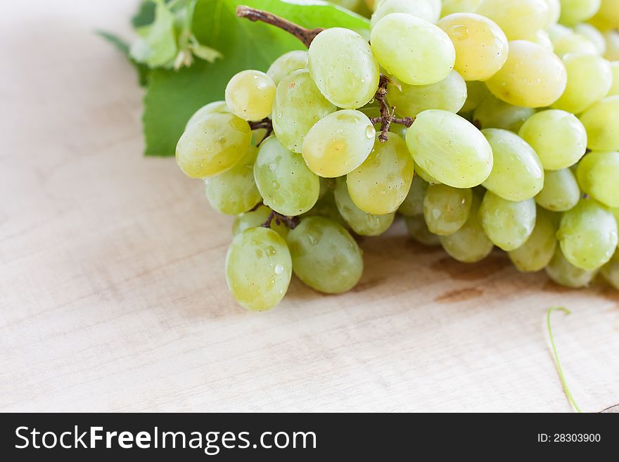 Ripe bunches of grapes wooden surface