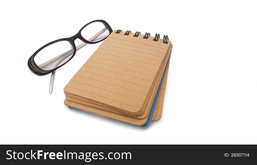 Notebook with glasses isolated on white