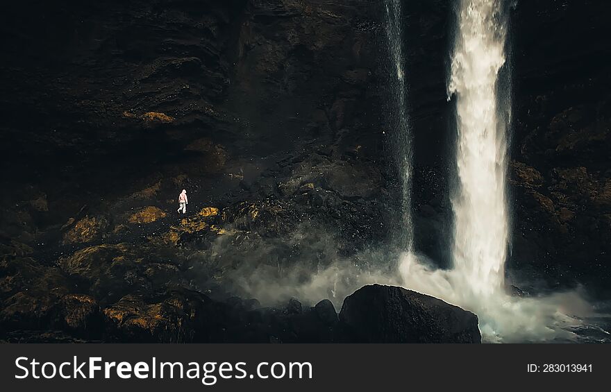 Female Tourist Walk On Pathway Visit Famous Kvernufoos Waterfall Landmark. Yellow Grass Hills On Kvernufoss Waterfall. Majestic Su