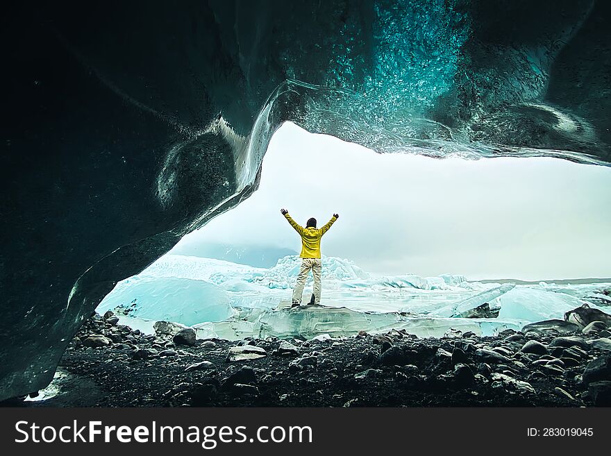 Panoramic viewpoint tourist by Fjallsjökull glacier in Iceland from inside glacier cave. Explore sightseeing Iceland spectacular