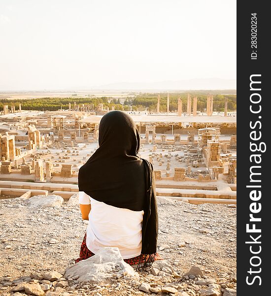 Tourist Woman Visit Famous Destination Sit On Viewpoint Above Persepolis. Explore Famous Historical Persian City Of Persepolis In