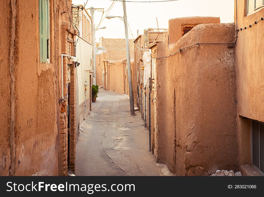 Kashan, Iran - 29th may, 2022: beautiful houses in Kashan neighborhood with car. Safety and lifestyle, siesta in hot summer day afternoon concept