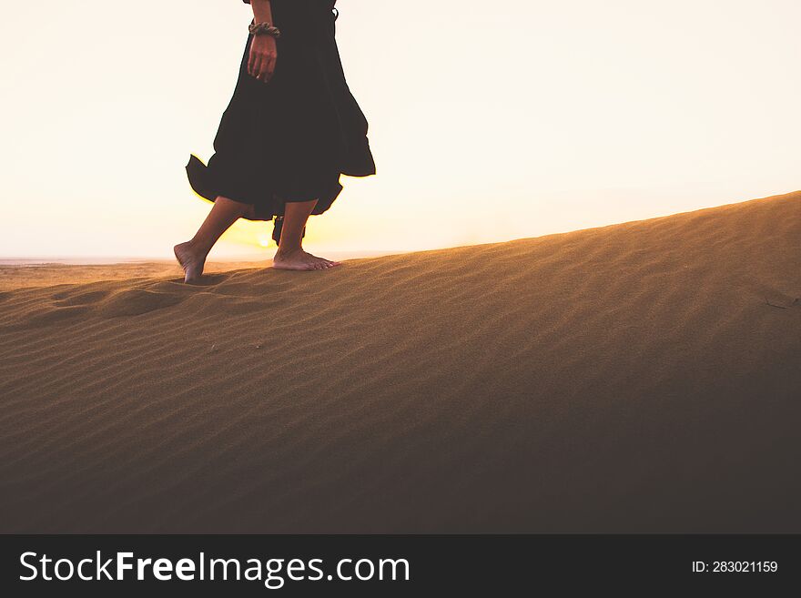 Low Angle Tracking View Beautiful Woman In Long Dress Feet Follow Walk On KAshan Desert Dunes