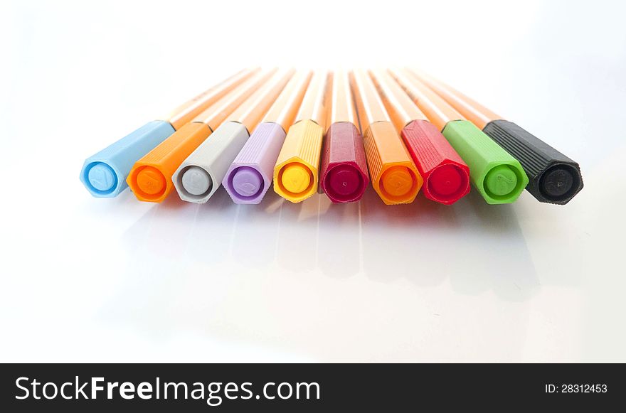 Colorful markers pens on White Background .