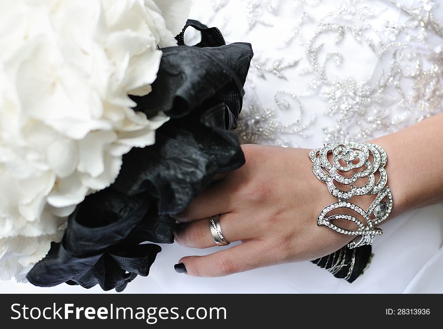 Wedding bouquet, hand and golden rings