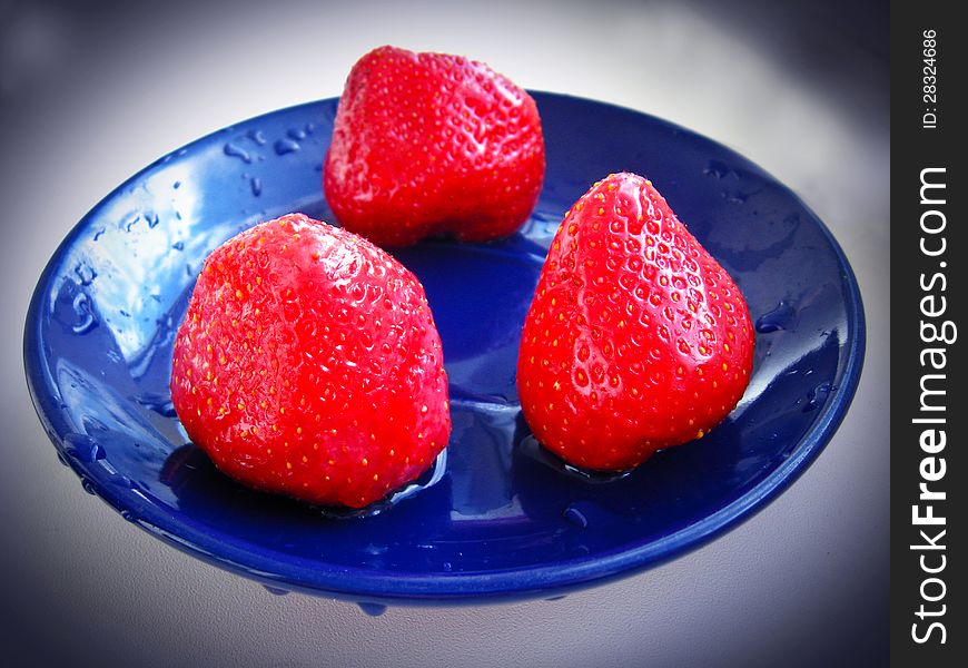 Three Ripe Strawberry On The Blue Plate