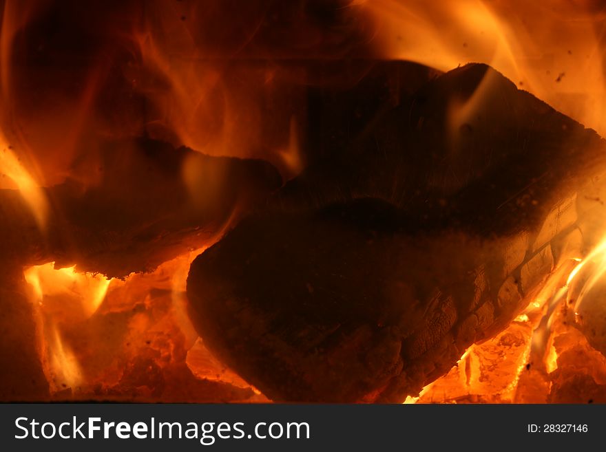 Hot coals inside a fireplace.