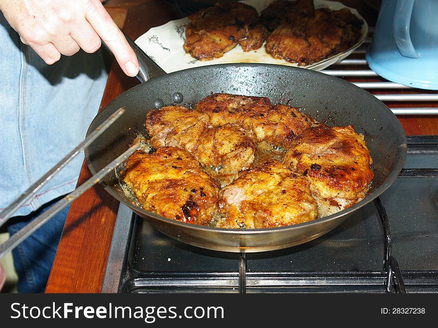 Famous German Wiener Schnitzel made in an iron pan by a chef. Famous German Wiener Schnitzel made in an iron pan by a chef