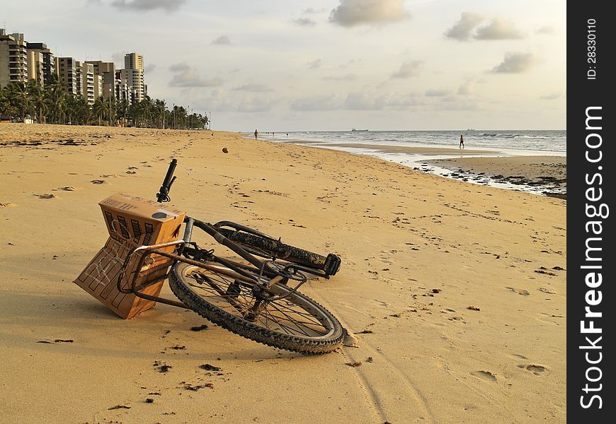 Bicycle lying on the sand of a beautiful beach in Recife, Brazil. Bicycle lying on the sand of a beautiful beach in Recife, Brazil
