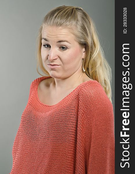 Woman shows disgust. The photo was made in studio.