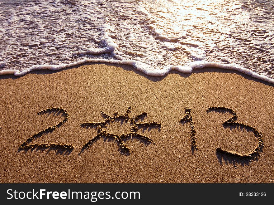 Sunny 2013, digits written on the sand. Sunny 2013, digits written on the sand