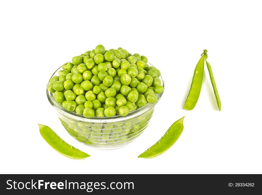 Pea balls in glass bowl on white background with null pods. Pea balls in glass bowl on white background with null pods.