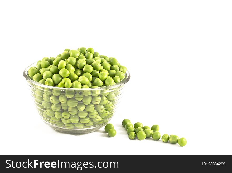 Pea balls in glass bowl on white background.