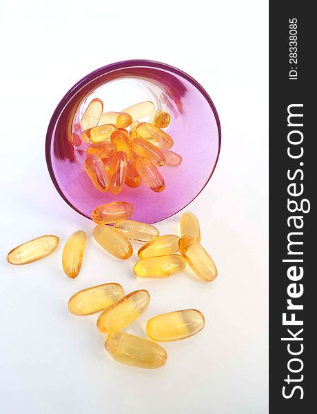 Supplement pills with glass on white background