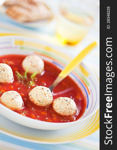 Tomato soup with vegetables and turkey meatballs, selective focus