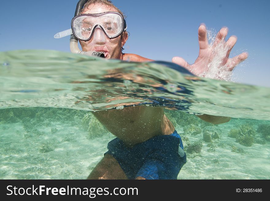 Happy man with snorkel mask in ocean