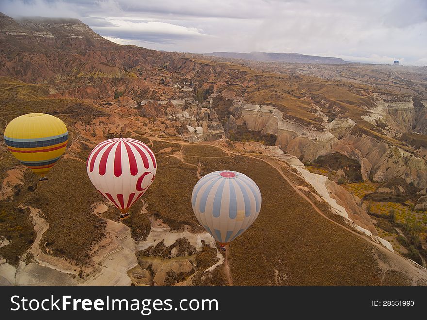 Three bright floating balloons in the cloudy day. Three bright floating balloons in the cloudy day