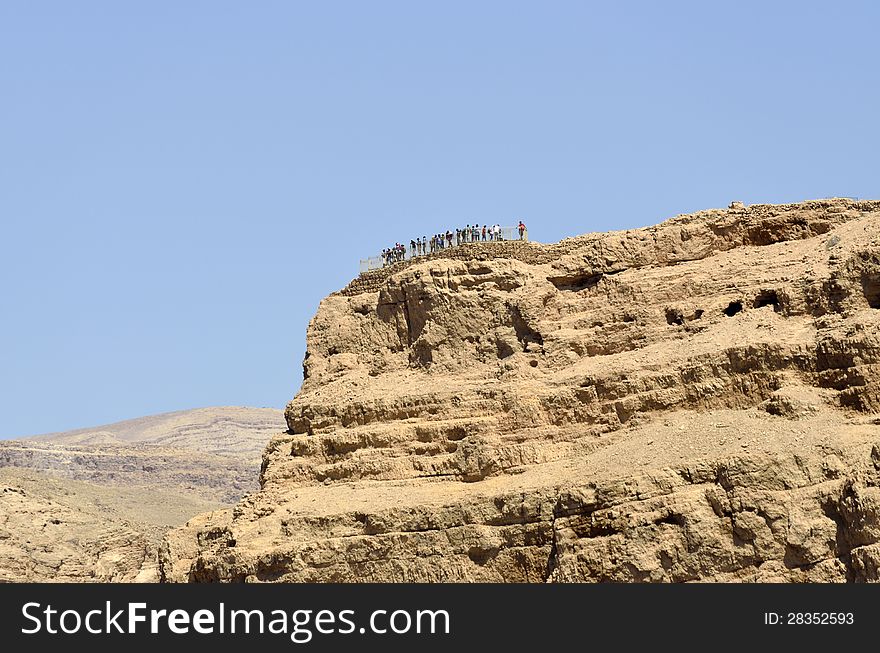 Tourists on the top of Masada stronghold in Judea desert, Israel. Tourists on the top of Masada stronghold in Judea desert, Israel.