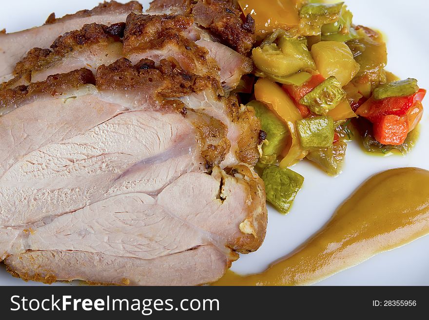 Sliced ​​turkey breast with vegetables and sauce, close-up. Sliced ​​turkey breast with vegetables and sauce, close-up.