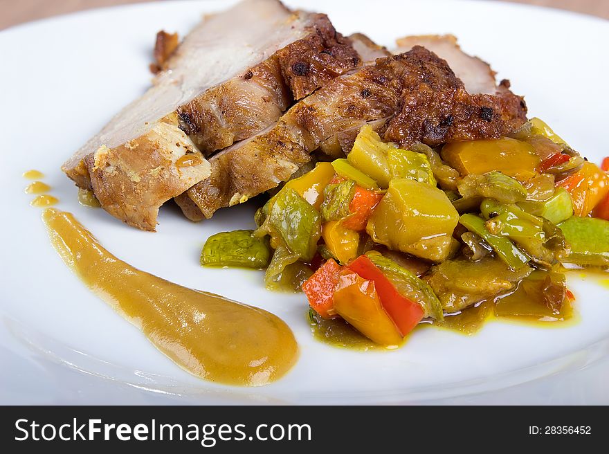 Sliced ​​turkey breast with vegetables and sauce, close-up. Sliced ​​turkey breast with vegetables and sauce, close-up.