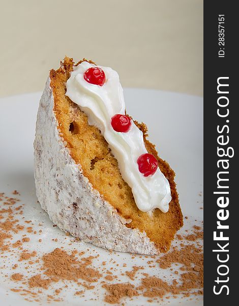 Piece of cake on a white plate with berries