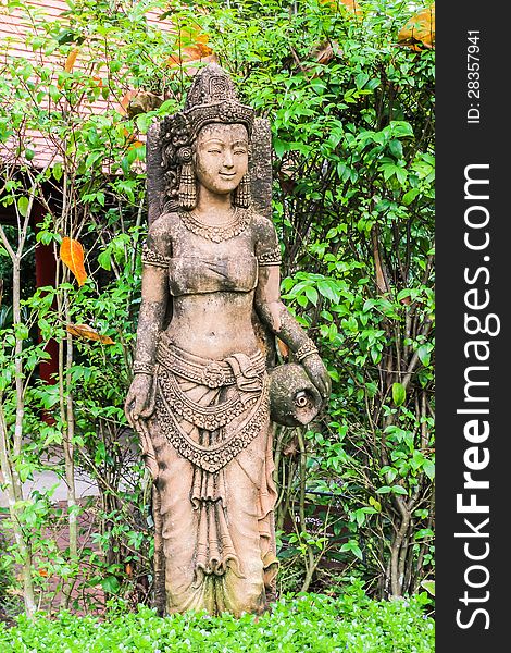 Ancient Cambodian style woman sculpture in Thai botanic garden