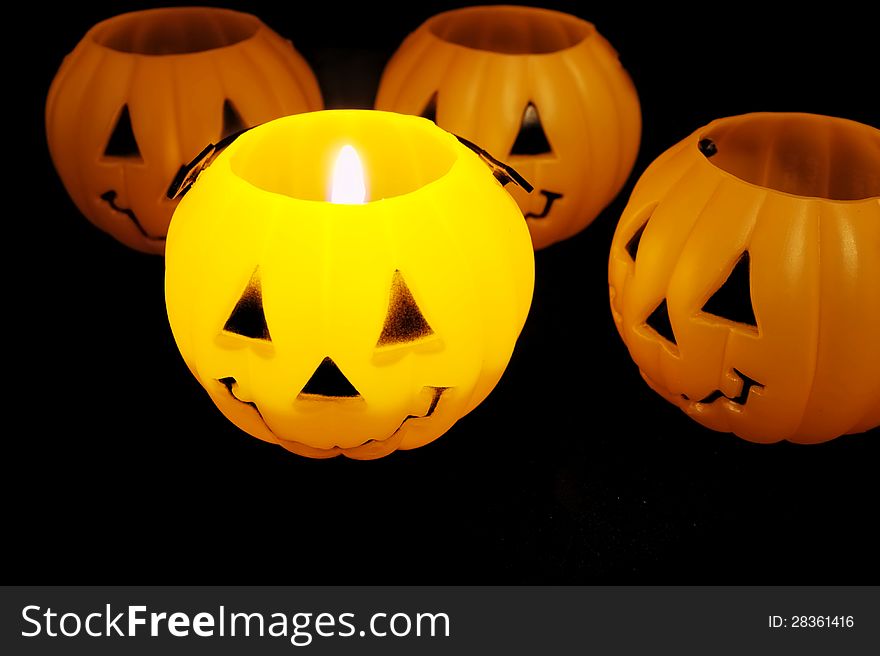 Glowing jack o lantern illuminated by candle