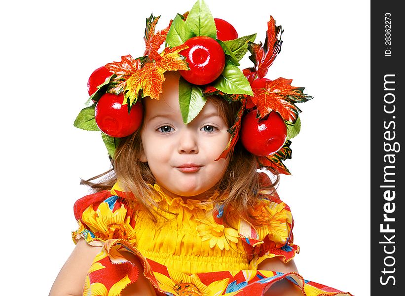 Portrait of a beautiful little girl in a wreath of leaves and apples. Portrait of a beautiful little girl in a wreath of leaves and apples
