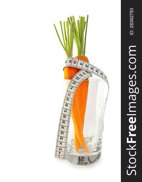 Fresh whole carrots in glass with measuring tape isolated on white background. Fresh whole carrots in glass with measuring tape isolated on white background