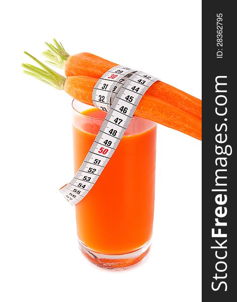 One glasses of healthy freshly blended carrot juice accompanied by whole ripe carrot isolated on white