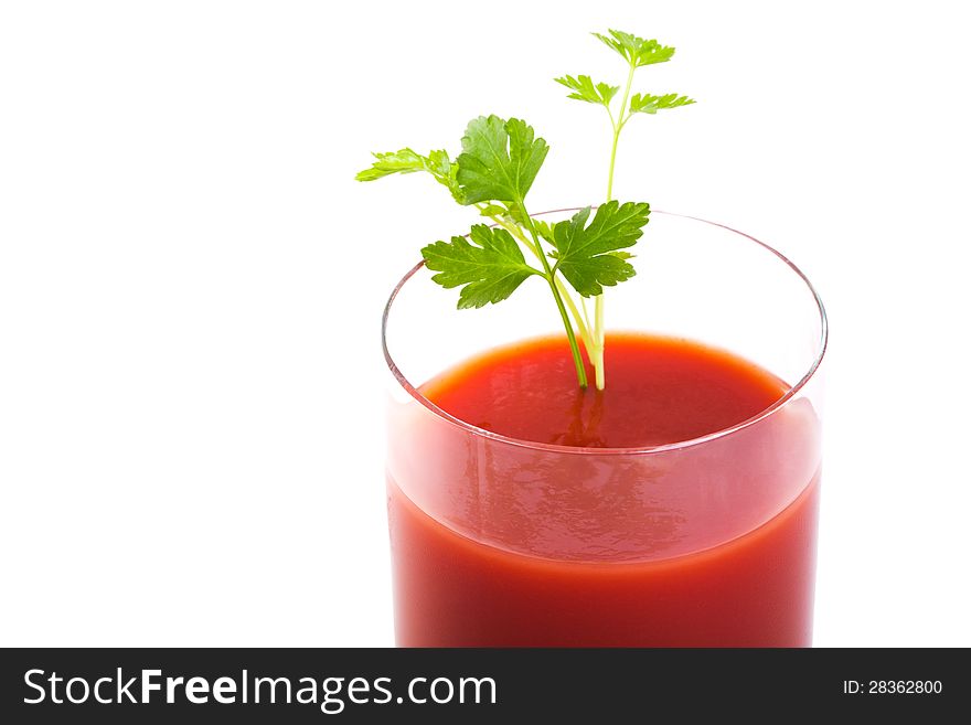 One glasses of healthy freshly blended tomato juice accompanied by whole parsley isolated on white