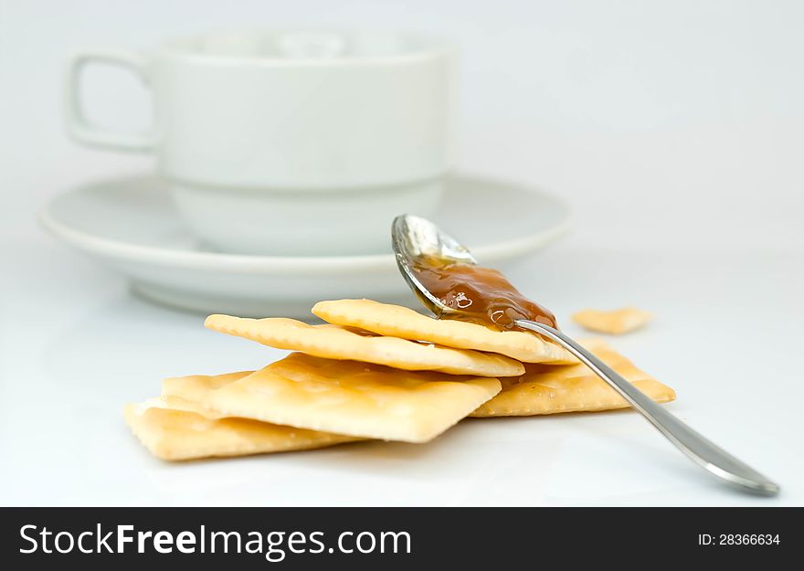 Saltine crackers and jam On a white background.