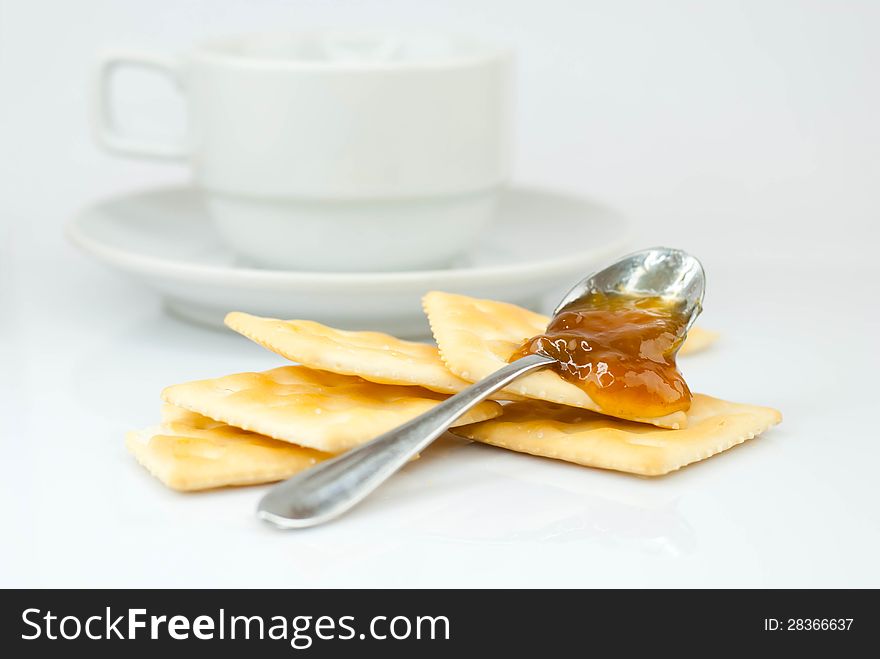 Saltine crackers and jam On a white background.