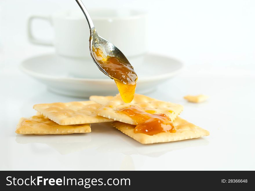 Saltine crackers and jam On a white background.