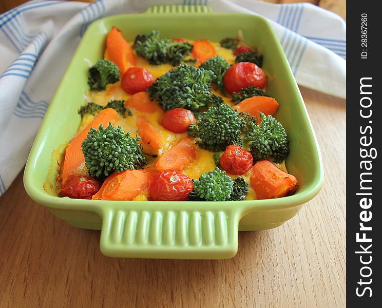 Gratin with broccoli,cherry tomatoes and carrots (close up)