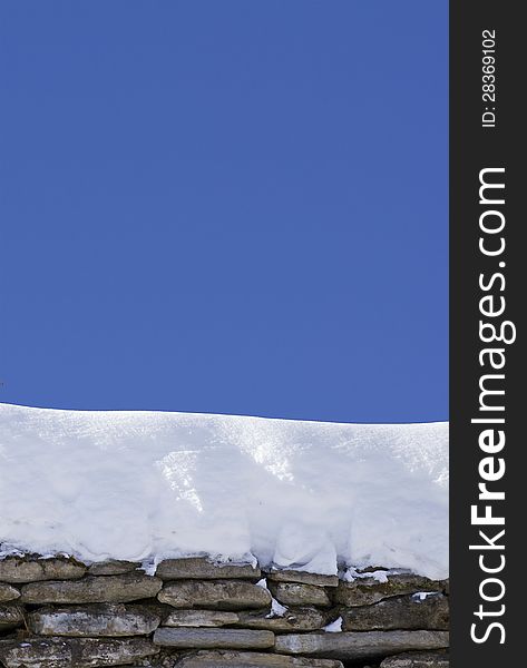 Rock structure with snow on it over blue clear sky. Rock structure with snow on it over blue clear sky
