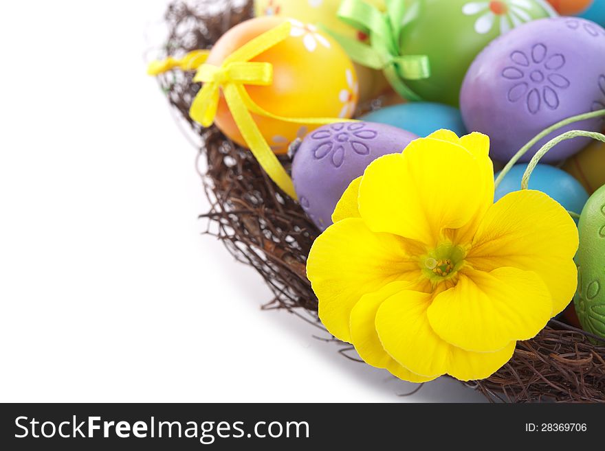Wooden basket full of colorful Easter eggs on white background with copy space. Wooden basket full of colorful Easter eggs on white background with copy space