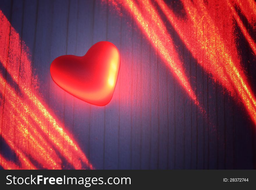 Red heart in the light of the laser