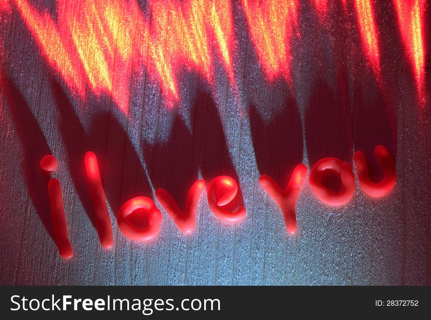 Sign of love from the polymer in the light of the laser on a wooden board. Sign of love from the polymer in the light of the laser on a wooden board