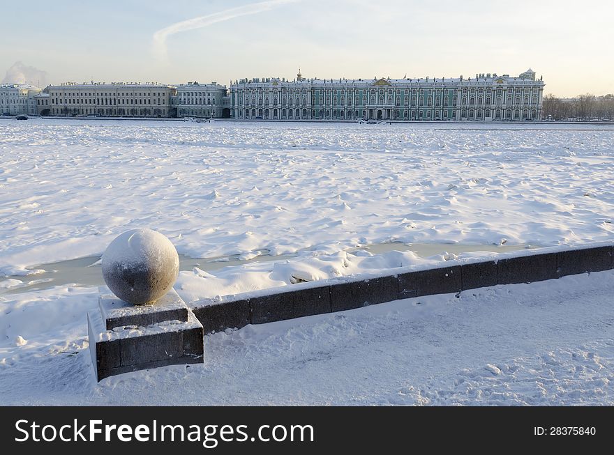 Winter cityscape of St.Petersburg by winter time with frozen Neva river and Winter Palace building behind