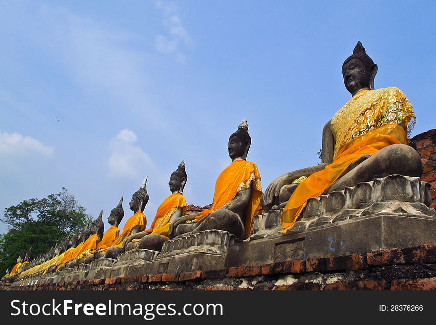 Ancient buddha image line up with blue sky at wat Yai Chaimongkhon, Ayutthaya, Thailand