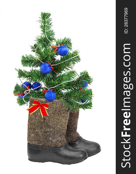Decorated Christmas tree and boots on a white background