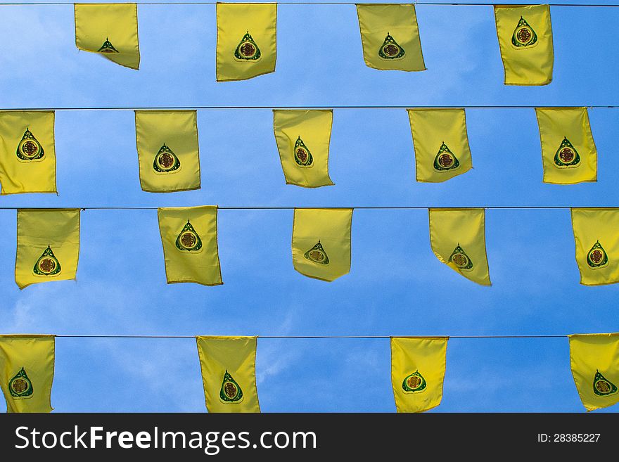Raw of yellow buddha flag on blue sky backgruond
