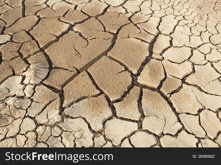 Cracked clay ground into the dry season. Cracked clay ground into the dry season