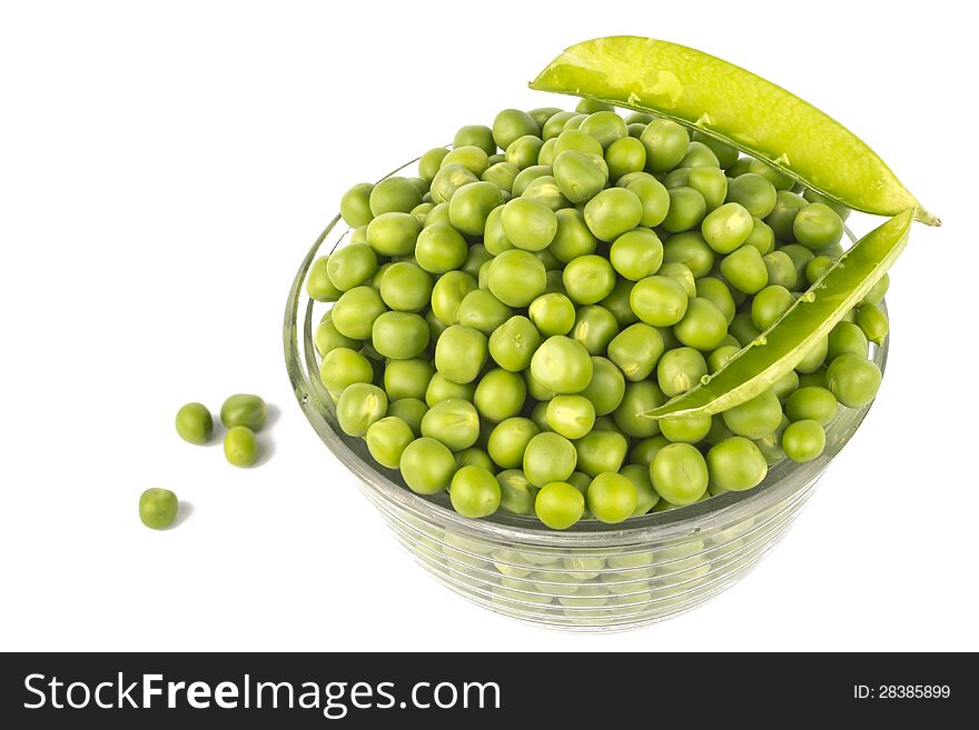 Pea balls in glass bowl on white background.